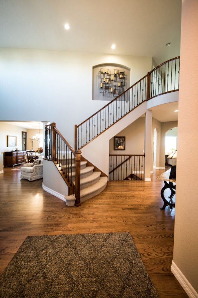 Crafting Captivating Headlines: Your awesome post title goes here Spacious modern interior showcasing a stylish wooden staircase and elegant decor.